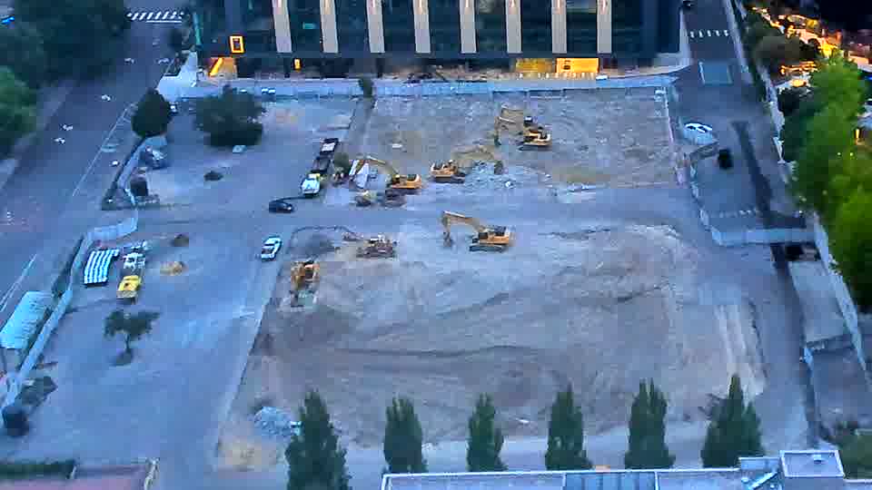 The arrangement of equipment on the site remains consistent between these views, with no apparent shifts in position.