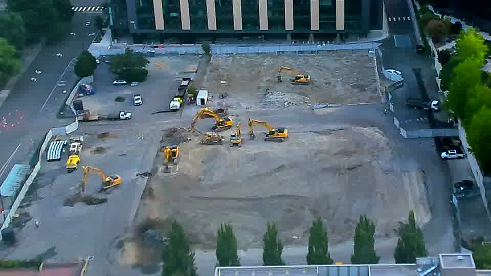 One of the excavators near the center of the frame has shifted its position slightly to the south.