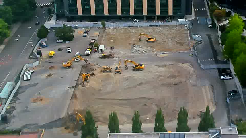 The arrangement of the heavy equipment remains largely static, though a small pile of material has shifted near the center.