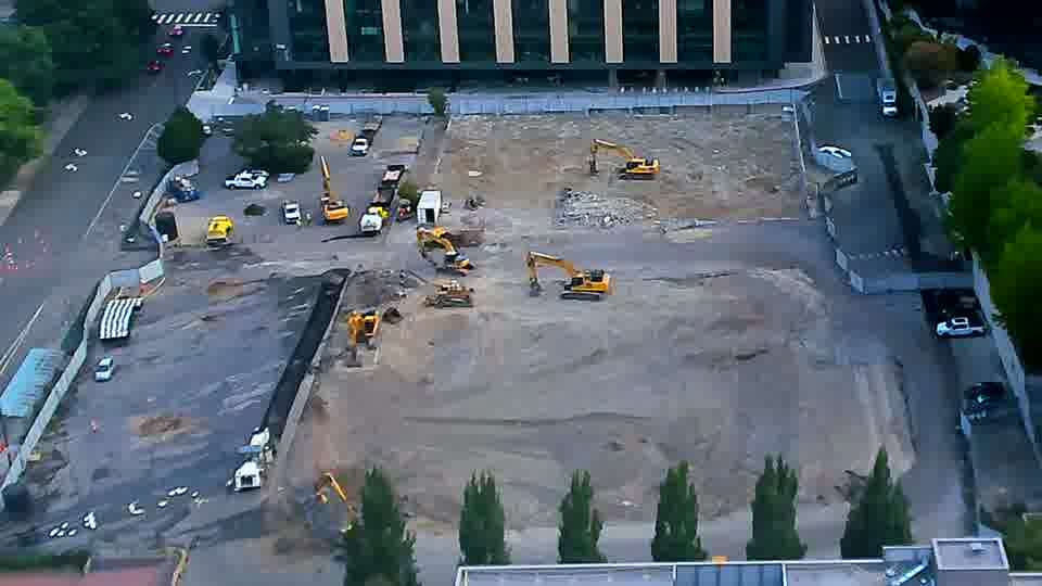 A few more vehicles are now visible parked along the service road on the right side of the frame.