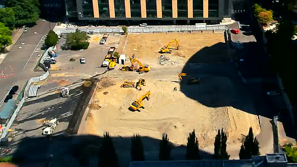 The scene remains remarkably consistent, with no visible movement of equipment or alterations to the material layout.
