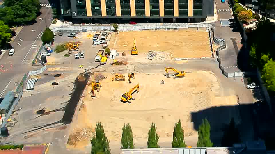The machines across the site appear to be holding their positions, with only a slight alteration in the arrangement of material near the foreground.