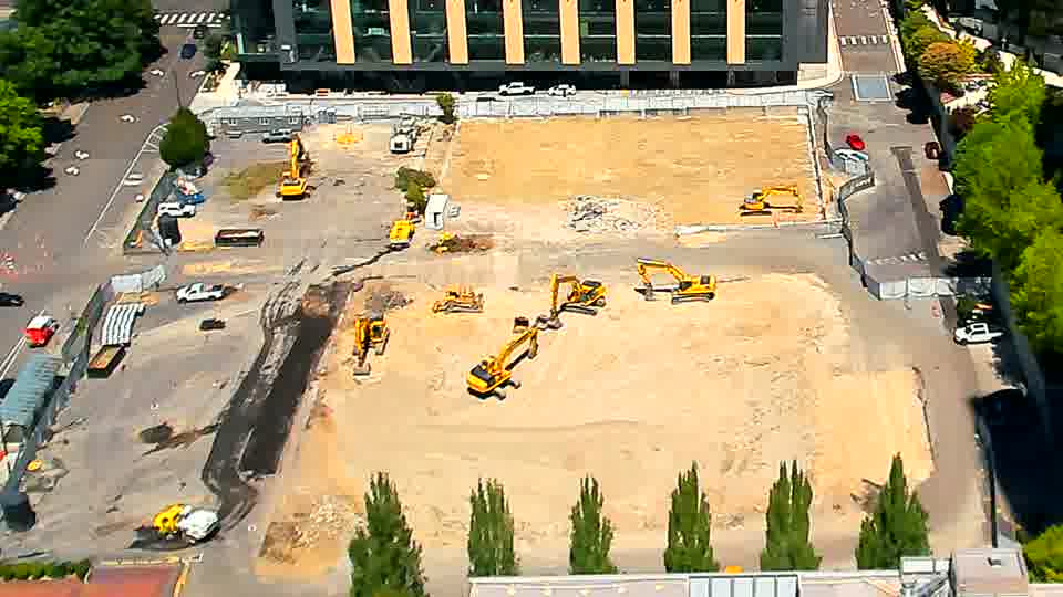 The arrangement of the equipment and material across the site remains remarkably consistent, though a small amount of material has been moved near the center.