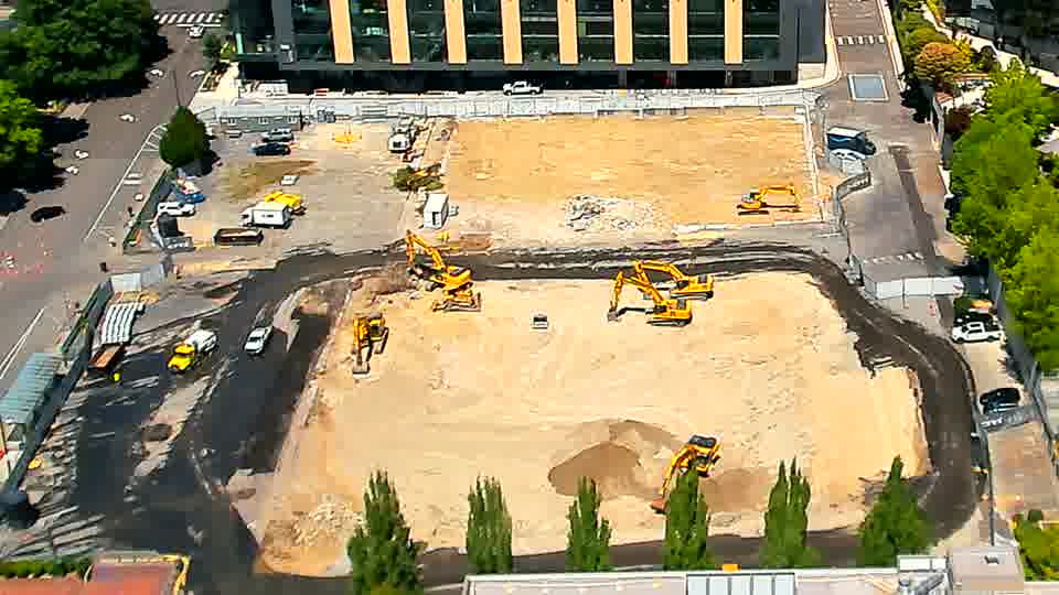 The site shows minimal alteration, with the machines and material piles holding relatively stable positions.
