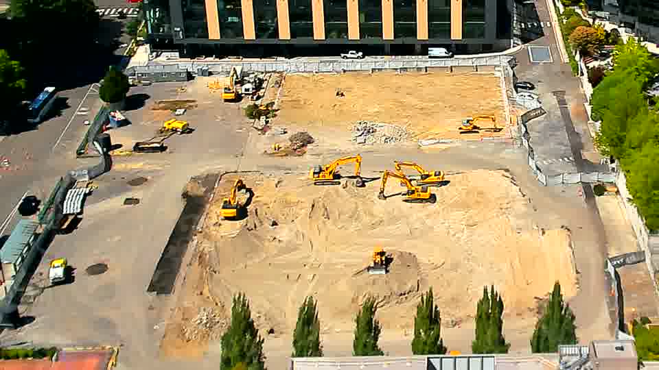 The site presents a similar view as before, with the heavy equipment remaining in largely the same locations.