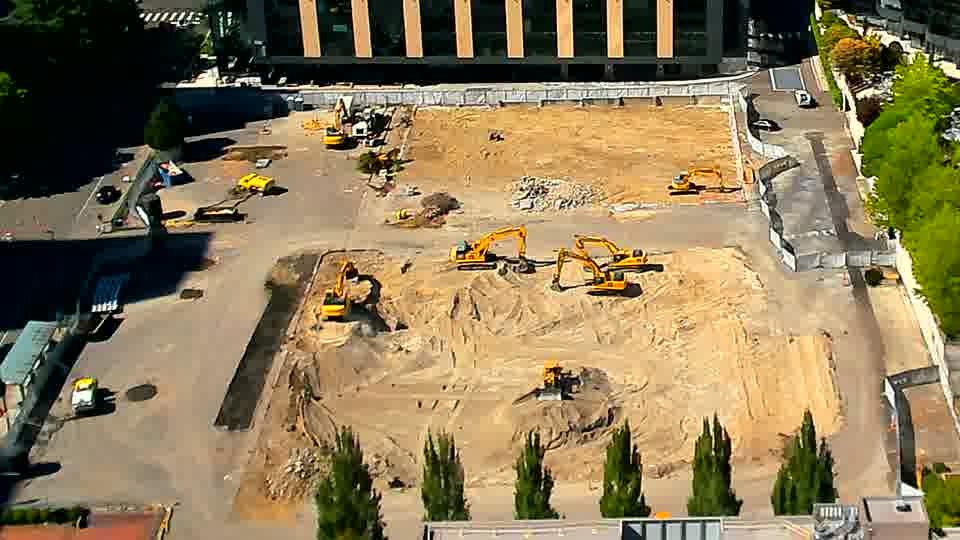 The scene shows little alteration, with the machines and stockpiled material appearing in the same arrangement as before.