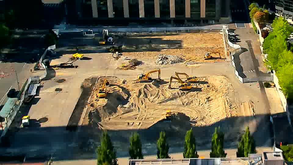 The arrangement of the machines and piles on site is remarkably similar, with only minor adjustments to shadows across the area.