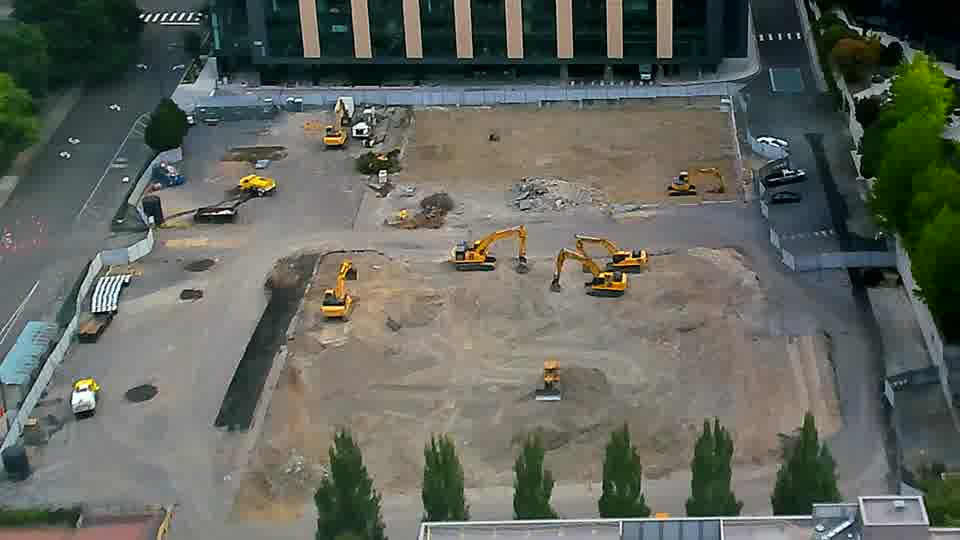 The site appears quiet, with the positions of the machines remaining consistent between these views.