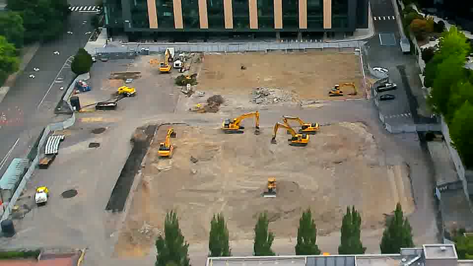 The site presents a similar view as before, with the heavy equipment remaining in roughly the same locations.