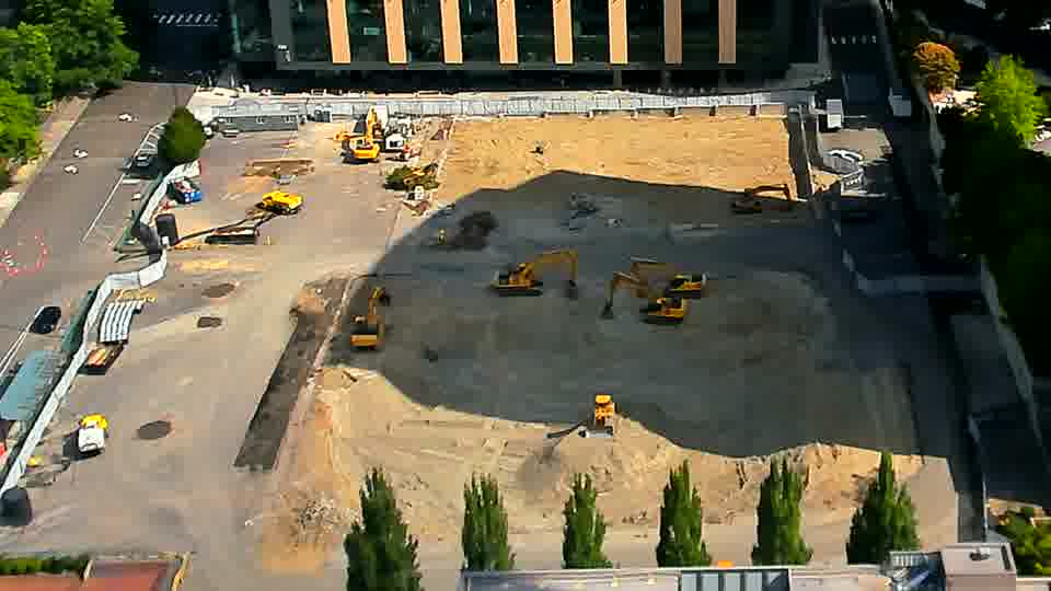The shadows have shifted slightly across the site, but the positions of the machines appear constant.