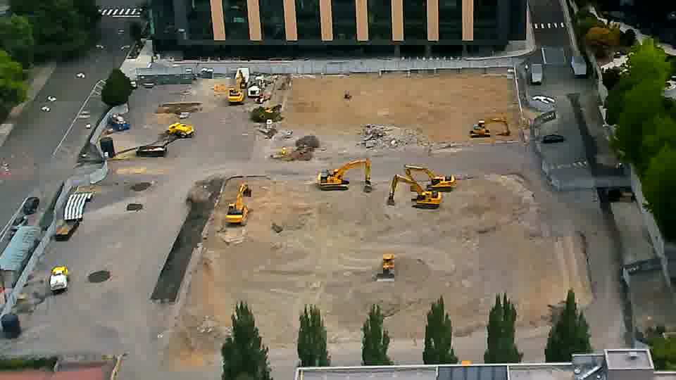 One of the excavators near the center of the site has shifted its position slightly, turning to face a different direction.