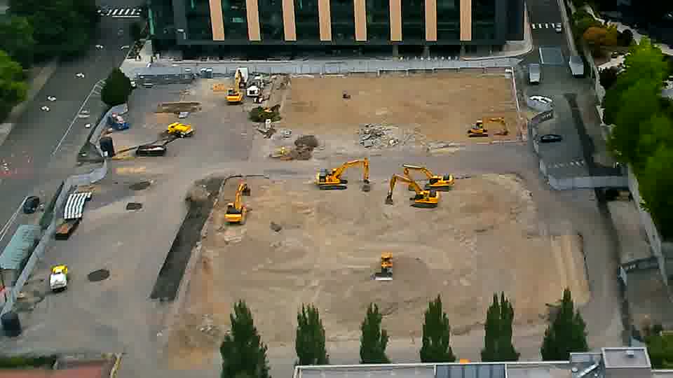 A small yellow vehicle has moved from the far left side of the frame to a position near the center.