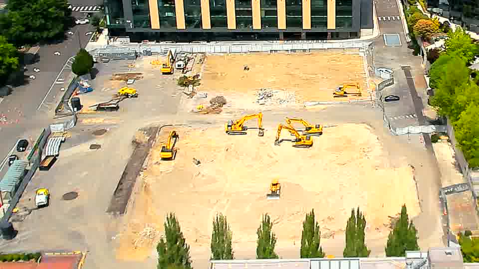 A small, light-colored vehicle is now visible near the center of the work area.