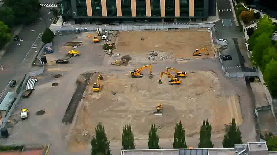 The equipment layout is almost identical to the previous view, though a small, light-colored vehicle has moved slightly toward the center.