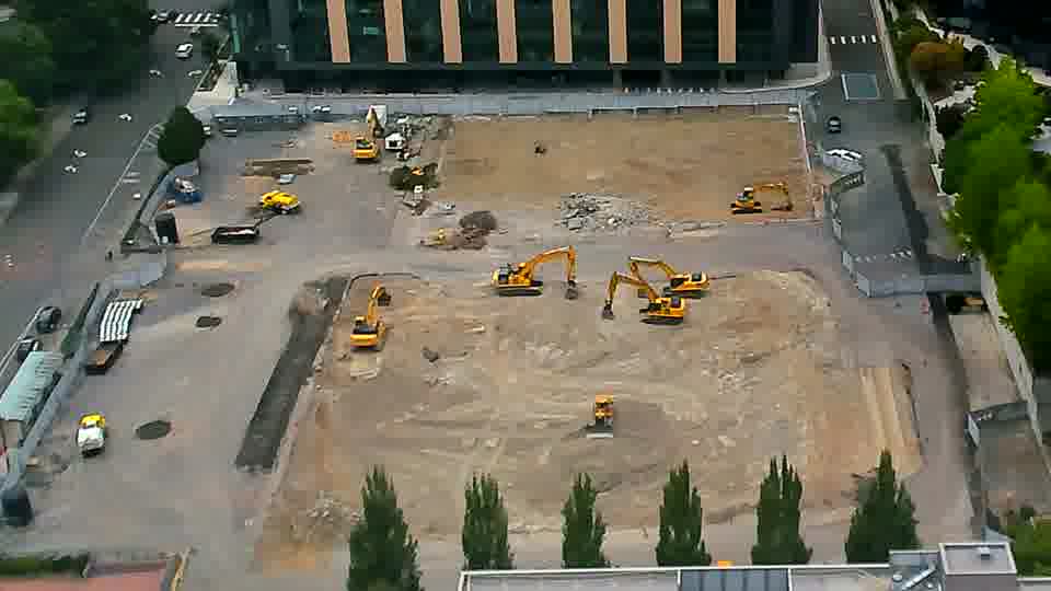 A small, light-colored vehicle is now visible near the bottom right corner of the frame, having appeared since the previous view.