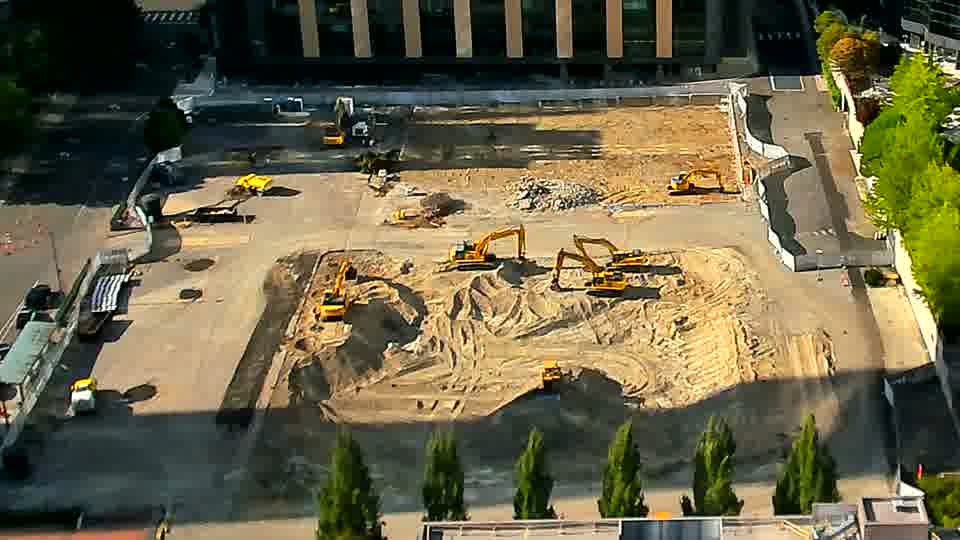 A white pickup truck has entered the site from the driveway on the left side of the frame and is now parked near the center.
