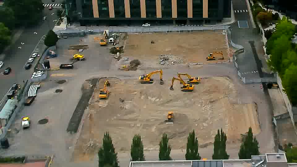 The arrangement of equipment across the site appears static, with no discernible shifts in position during the last quarter hour.