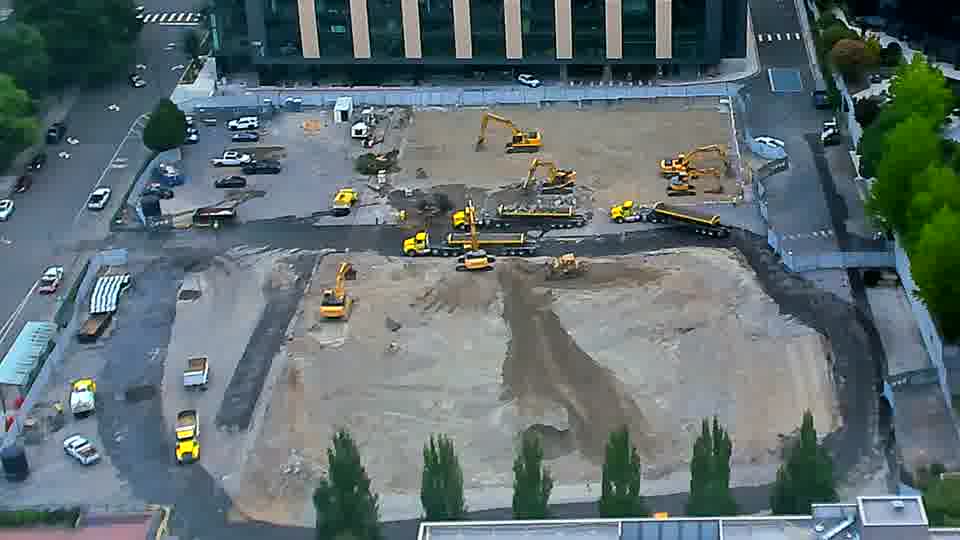 The layout of equipment across the site remains largely consistent, though a yellow machine near the center has turned slightly to the right.