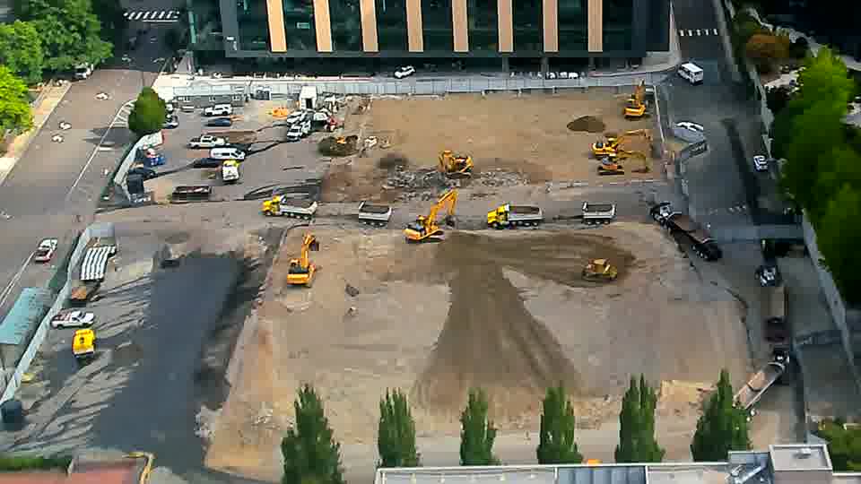 The heavy machinery maintains its positions, with no noticeable shifts across the work area in the last fifteen minutes.