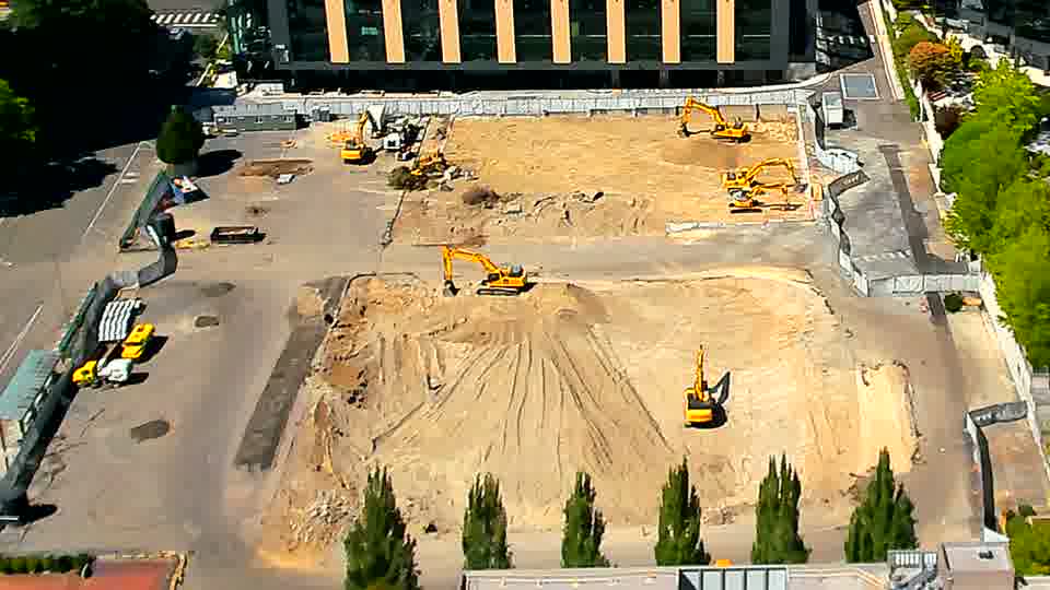The arrangement of machinery appears unchanged, though sunlight now falls across a slightly different portion of the work area.