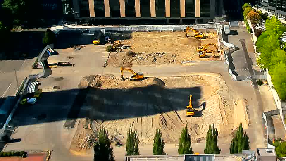 The scene remains largely unchanged, with the machines holding their positions in the work area.