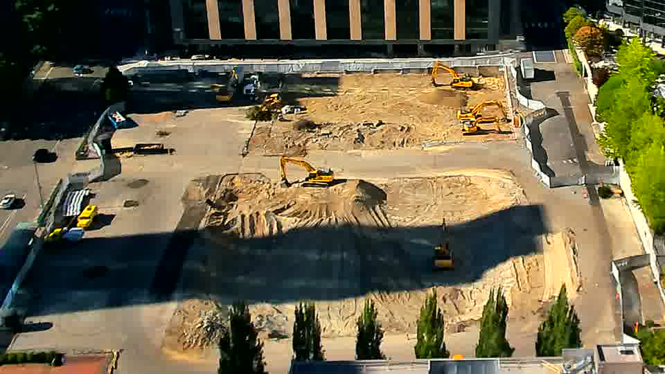 The arrangement of the heavy equipment appears stable, with no obvious shifts in position over the last quarter hour.