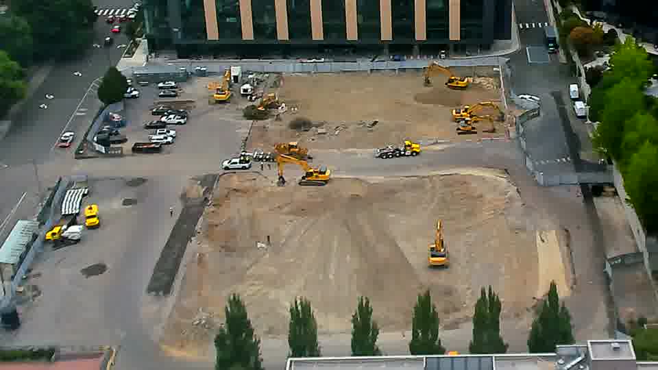 The overall scene is holding steady, with the arrangement of machines and material appearing virtually identical to the previous view.