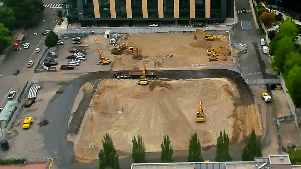 A single excavator has shifted its position slightly toward the center of the work area.