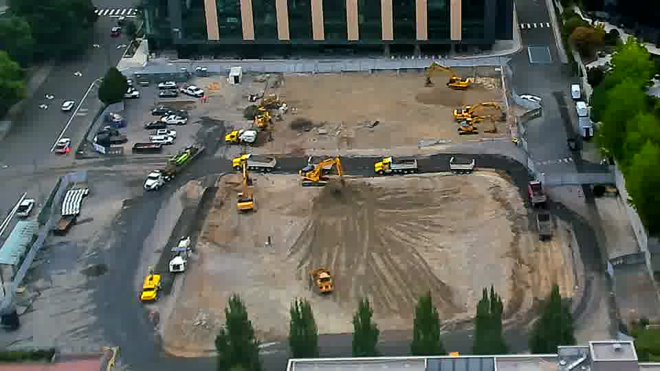 A small loader has moved from the right side of the frame to a position near the center.