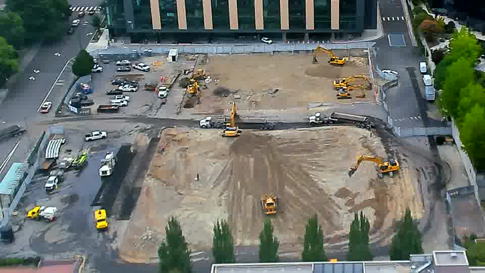 One of the excavators near the lower-right corner has moved a short distance to the left.