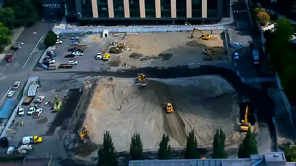 The arrangement of equipment remains stable, though a small excavator near the center has shifted position slightly toward the lower right.