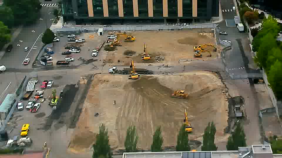 The site presents a similar view as before, with no significant alterations to the equipment arrangement or vehicle traffic.