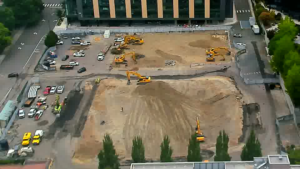 The equipment arrangement across the site remains consistent, with no noticeable shifts in machine positions or vehicle movements.