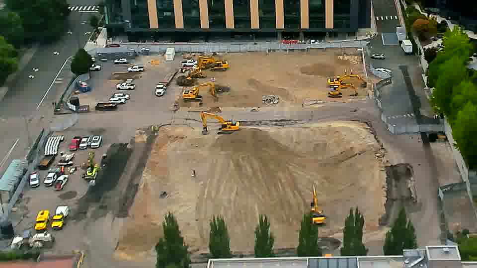 The scene remains remarkably static, with the machinery maintaining its positions across the site.