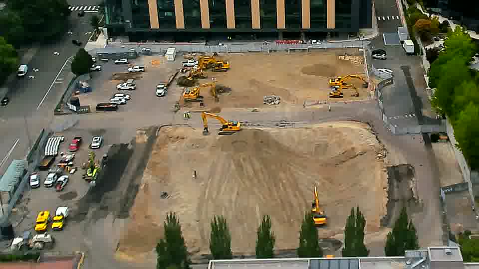 The site appears largely unchanged, with the machines holding their positions and no new vehicle activity visible.