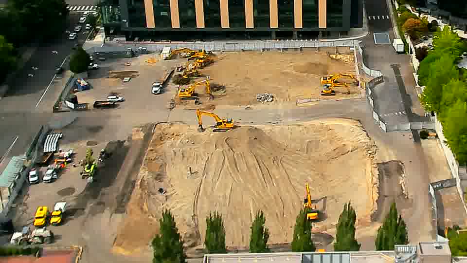 The site shows no significant alterations, as the machines and materials maintain their previous positions.