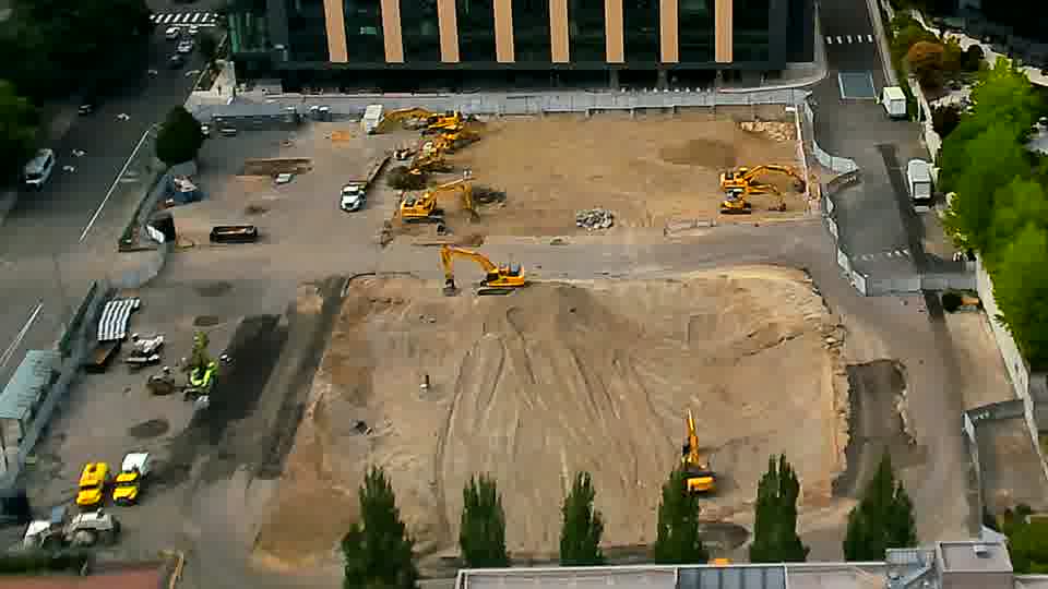 The scene remains remarkably stable, with all visible machinery and materials holding their prior locations.