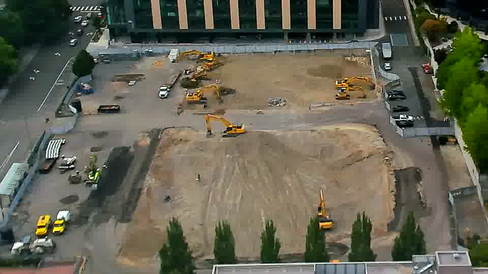 The scene remains largely unchanged, with the same arrangement of earthmoving equipment visible across the site.