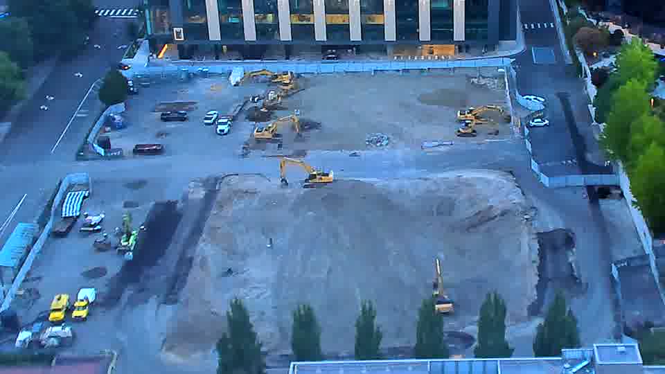 The arrangement of machinery on site remains largely unchanged over the past fifteen minutes.