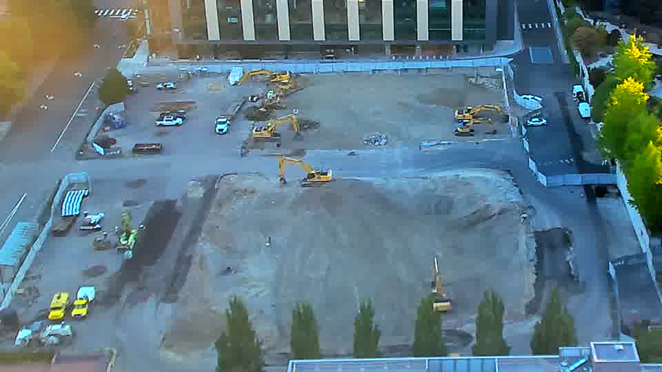 The site presents a consistent view, with the heavy equipment remaining in the same locations as before.