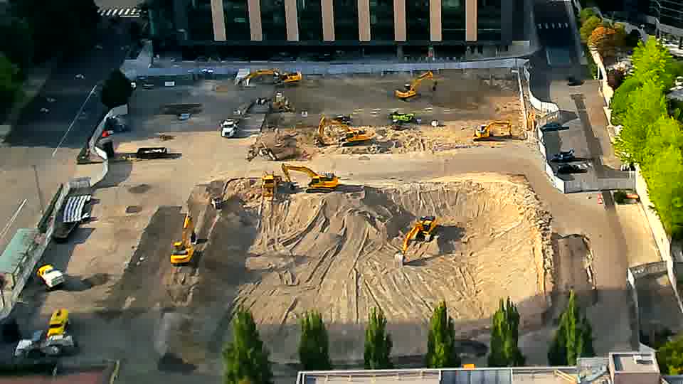 The equipment arrangement appears static, with no noticeable repositioning of machines or materials across the site.