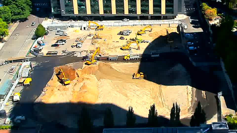 Shadows have lengthened across the site, but the arrangement of equipment appears to be holding steady.