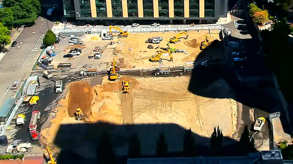 The arrangement of equipment across the site remains remarkably consistent, with only subtle shifts in shadow positions visible.