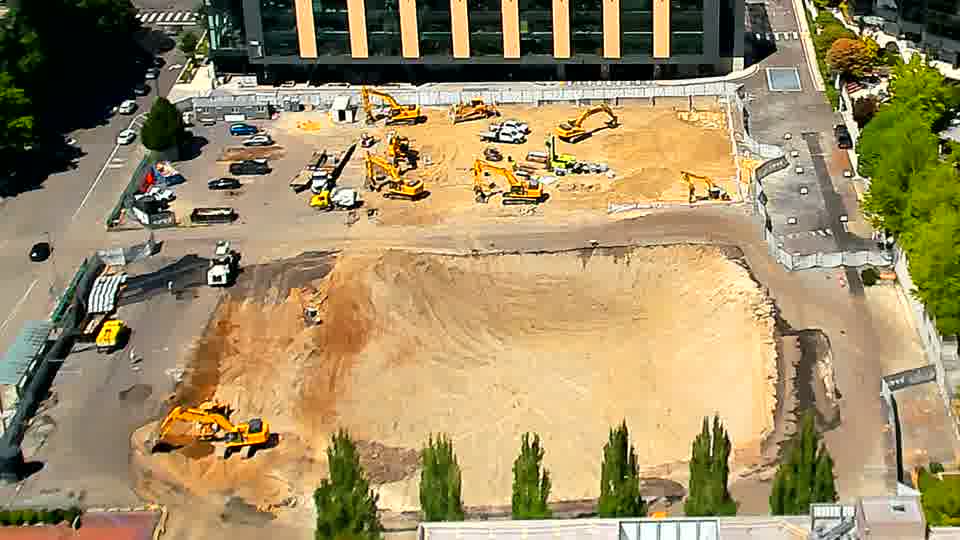 The site appears remarkably static, with no evident shifts in equipment or material placement over the last fifteen minutes.