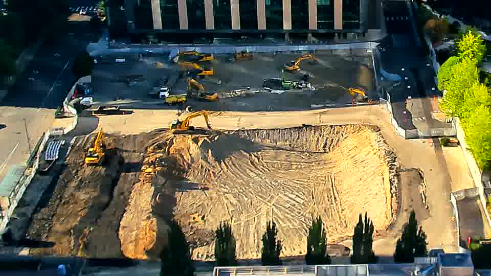 The site’s layout remains consistent, with the heavy equipment holding its positions across the graded area.
