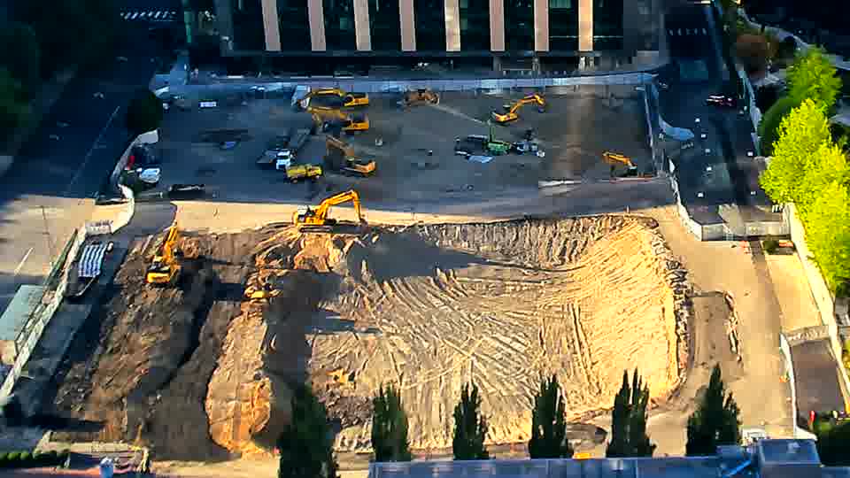 The site maintains its current appearance, with no obvious shifts in equipment or materials over the last quarter of an hour.