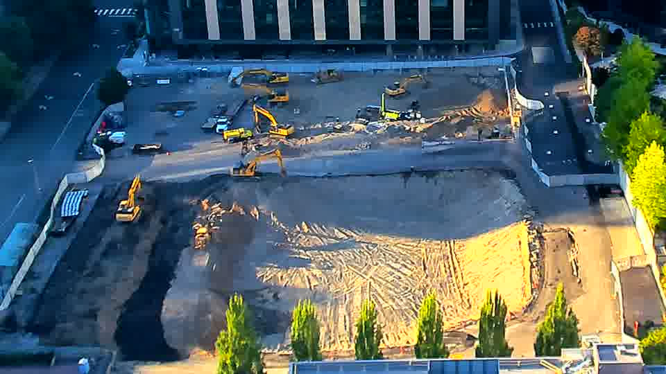 A single white van has entered the site via the driveway on the left side of the frame.