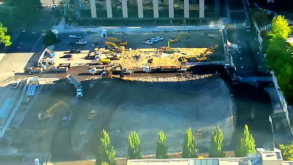 The overall layout of the site remains consistent, though a small amount of material appears to have been moved by the machines near the center.