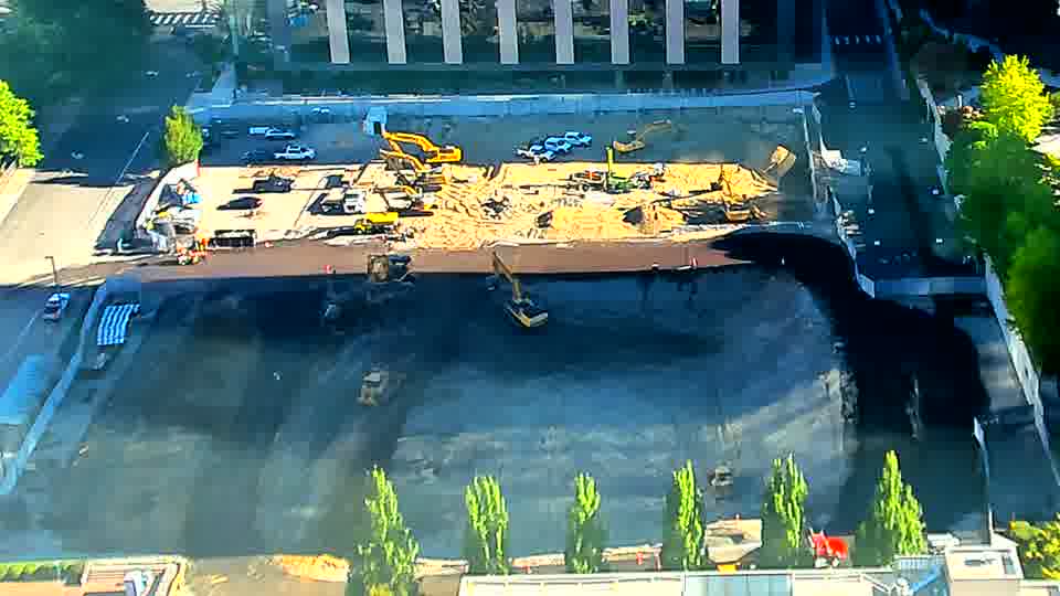 The equipment arrangement across the site is holding steady, though one of the machines near the lower-center appears to have made a slight turn.