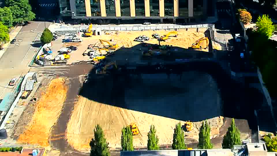 The equipment arrangement across the site remains largely static, although shadows have shifted slightly with the sun’s movement.